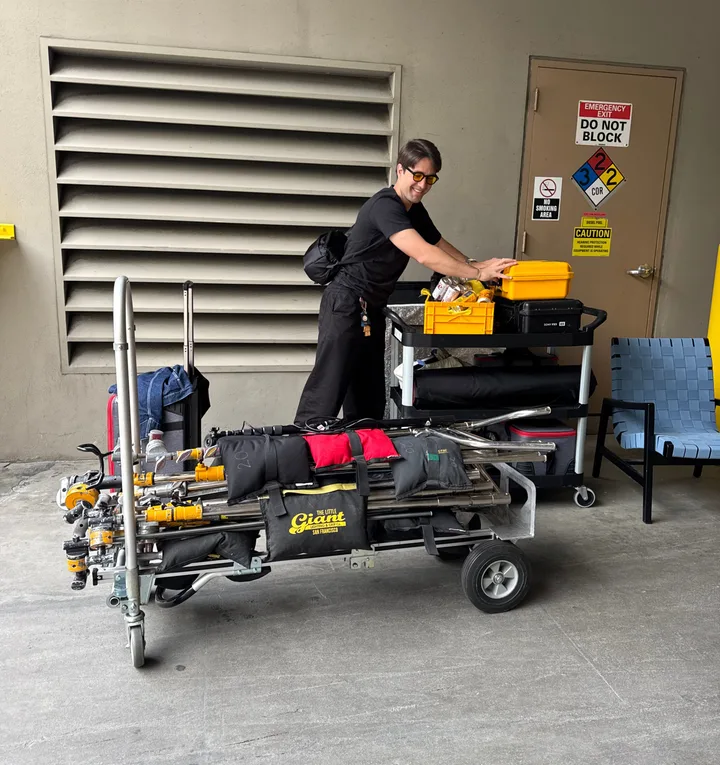 Graeme loading a cart of film lights and grip gear